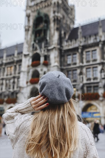 Woman wearing beret by New Town Hall in Munich, Germany