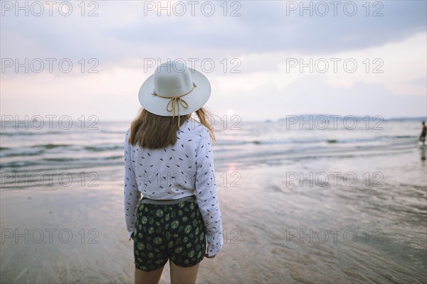 Young woman in sun hat on beach in Krabi, Thailand