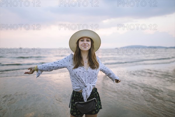 Young woman in sun hat on beach in Krabi, Thailand