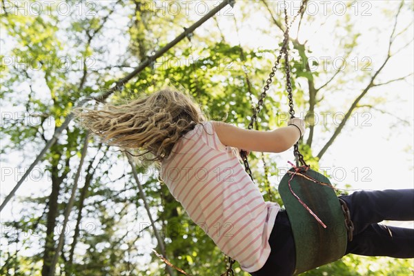 Girl wearing striped t-shirt on swing