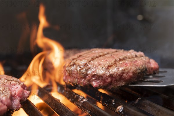 Hamburger patty on barbecue grill