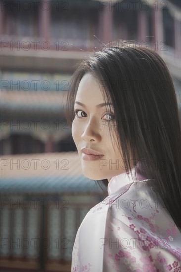 Portrait of young woman with black hair