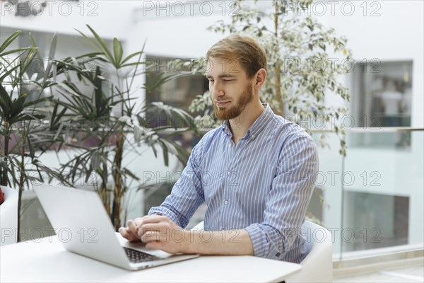 Man using laptop at table