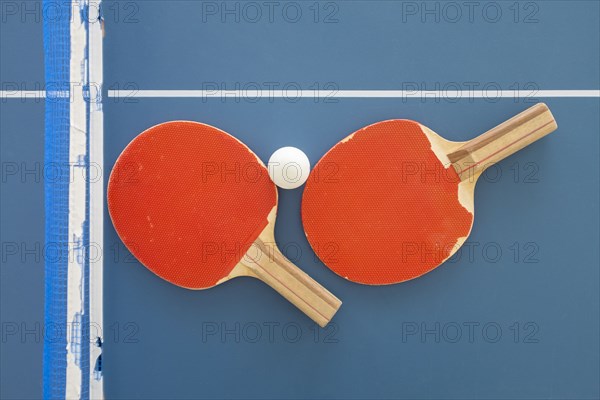 Ping pong paddles and ball on table