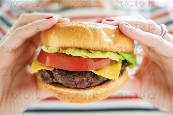 Woman holding hamburger