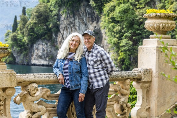 Smiling couple at Villa del Balbianello by Lake Como, Italy