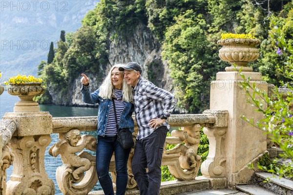 Smiling couple at Villa del Balbianello by Lake Como, Italy