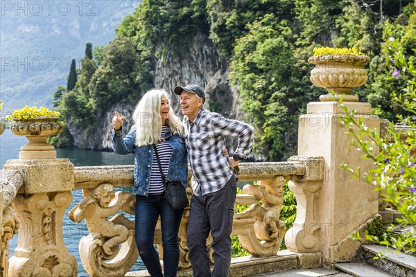 Smiling couple at Villa del Balbianello by Lake Como, Italy