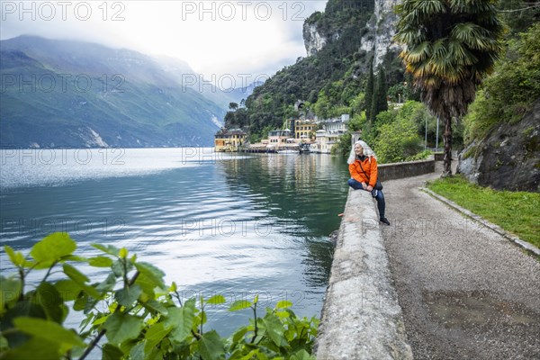 Woman on waterfront in Riva del Garda, Italy