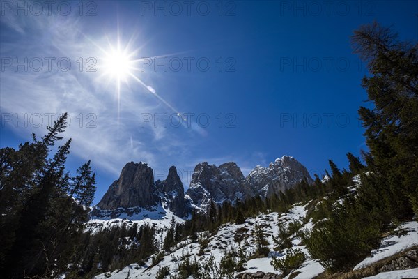 Sun over mountain range in Dolomites, Italy