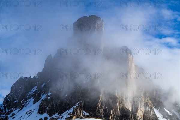 Ra Gusela mountain peak in fog in Dolomites, Italy