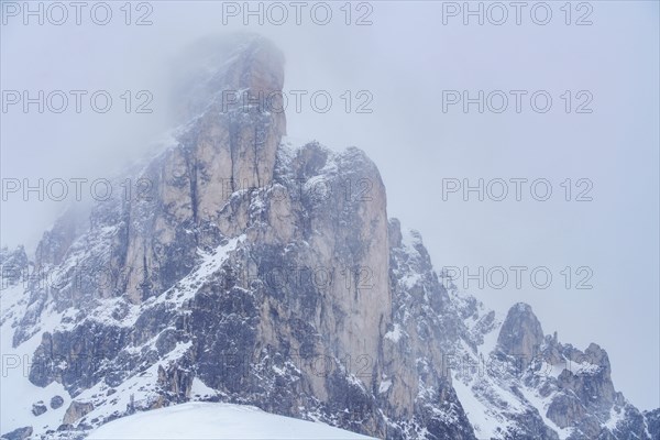 Ra Gusela mountain peak in fog in Dolomites, Italy