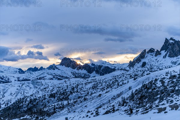 Mountain range in snow at sunset in Dolomites, Italy