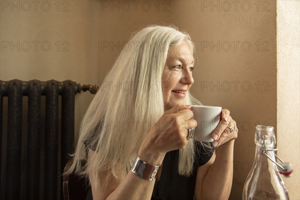 Woman holding coffee cup in cafe