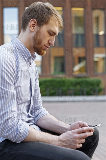 Bearded man using smart phone