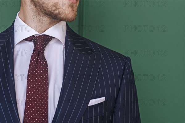 Man wearing pinstripe blazer with spotted tie