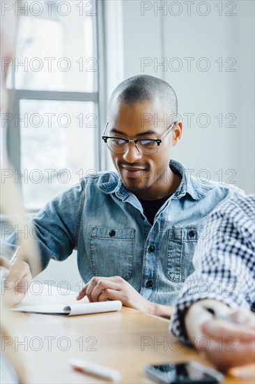 Man using note pad during meeting