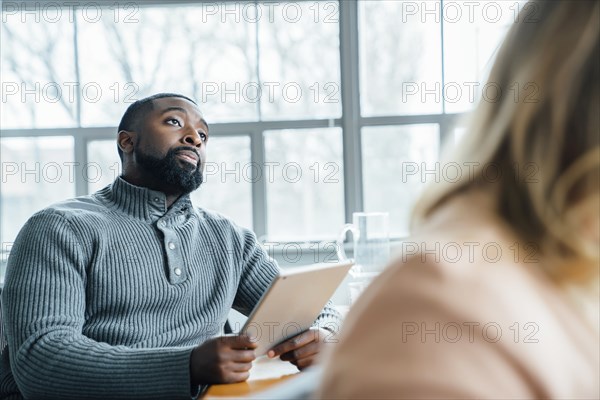 Man holding digital tablet during meeting