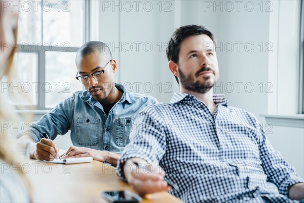 Coworkers in board room during meeting