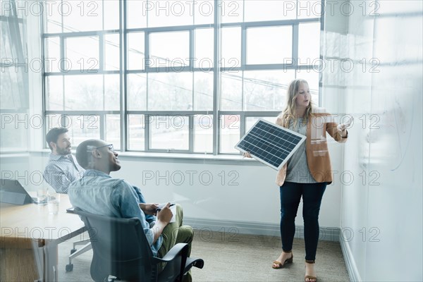 Woman using diagram during board room presentation