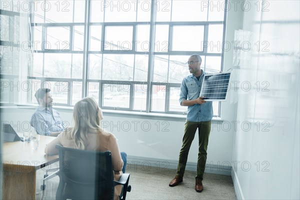 Man using diagram during board room presentation