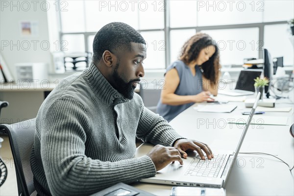 Man using laptop in office