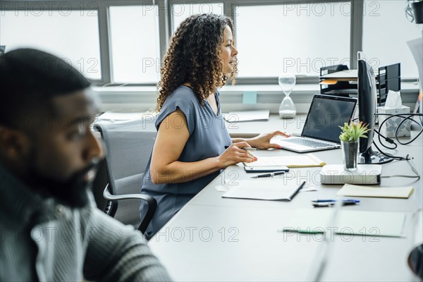 Woman using computer in office