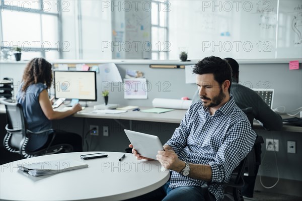 Man using digital tablet in office