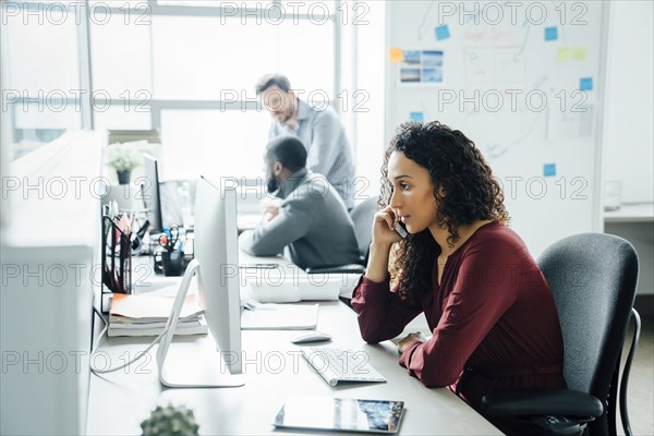 Woman taking phone call in office