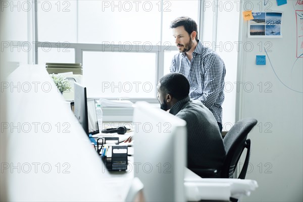 Men using computer in office