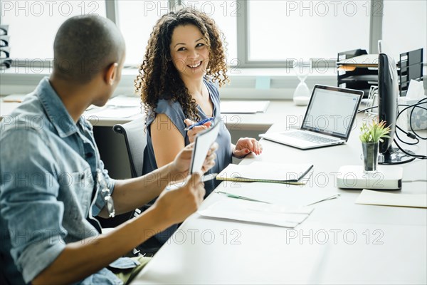 Woman smiling at coworker in office