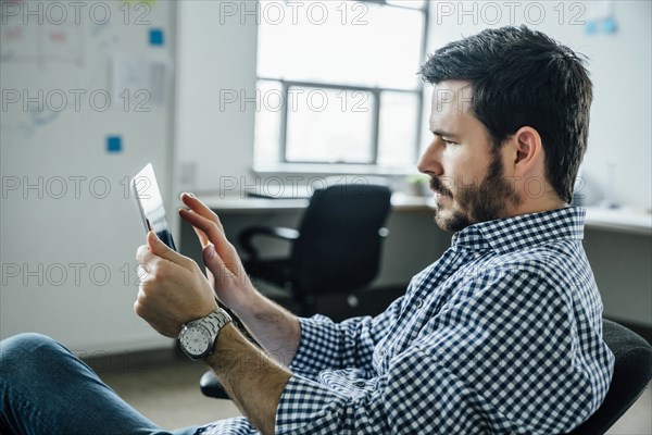 Man using digital tablet in office