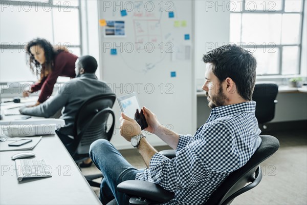 Man using digital tablet in office