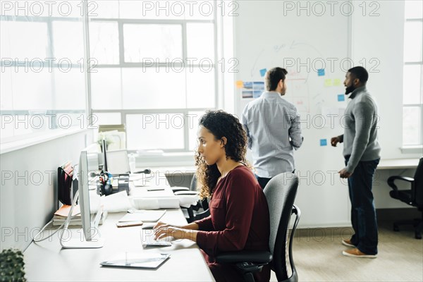 Woman using computer in office