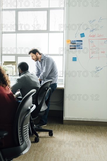 Workers by window in office