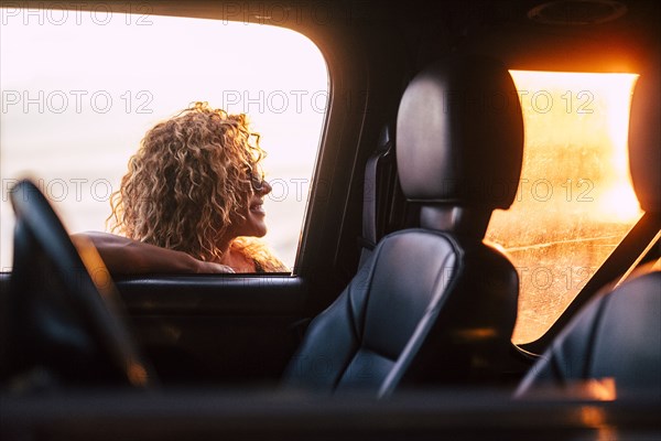 Smiling woman leaning on car window