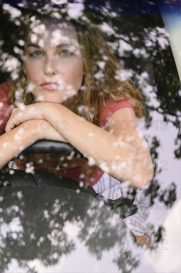 View through windscreen of young woman in car