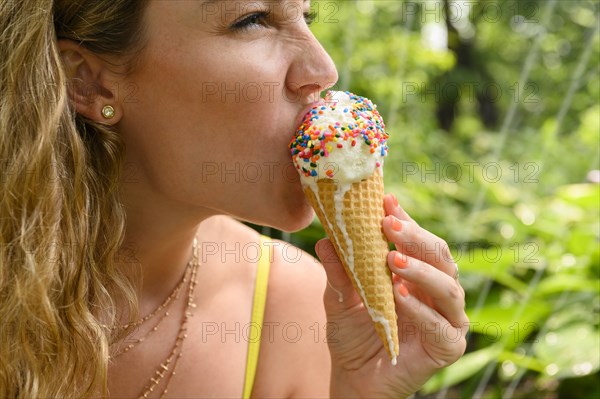 Young woman eating ice cream cone