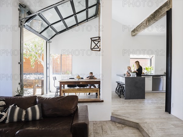 Mother and children in kitchen and dining room