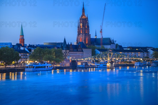 Cathedral by river at sunset in Frankfurt