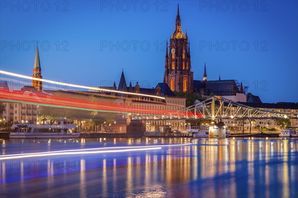 Light trails on river at sunset in Frankfurt