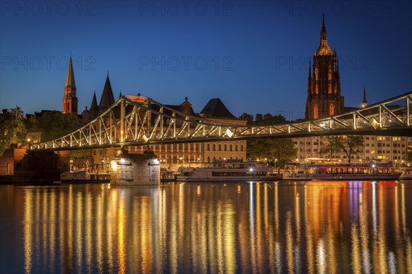 Bridge over river at sunset in Frankfurt