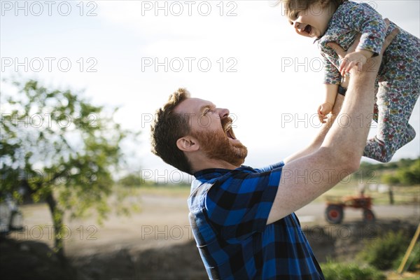 Father lifting baby girl