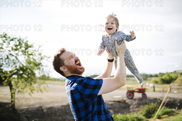 Father lifting baby girl