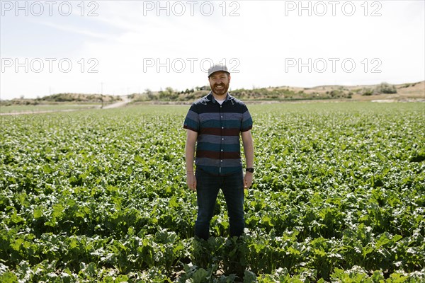 Smiling mid adult man in crop field