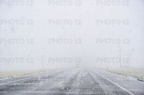 View through windscreen of car on highway during snow