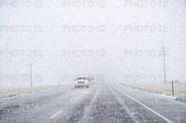 View through windscreen of car on highway during snow