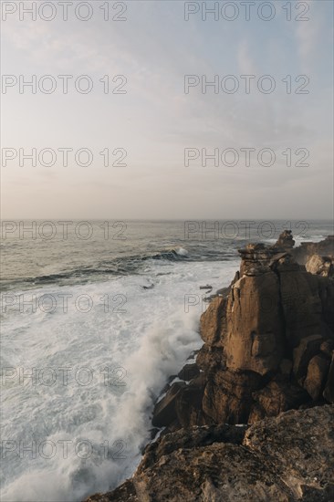 Cliff by sea at sunset in Peniche