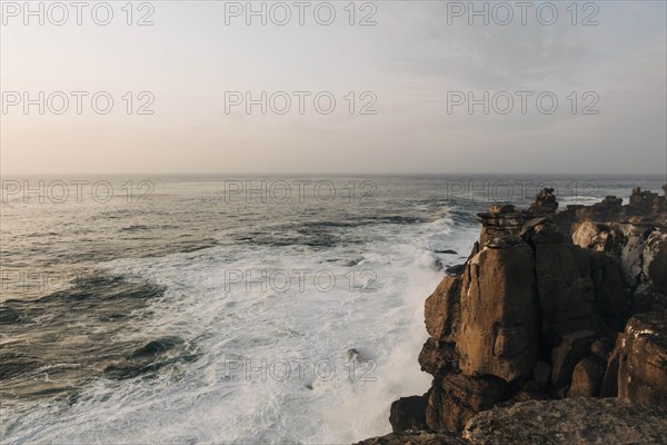 Cliff by sea at sunset in Peniche