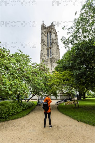 Woman photographing tower in Paris